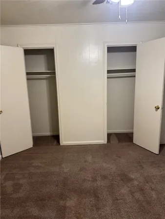 a view of an empty room with a kitchen