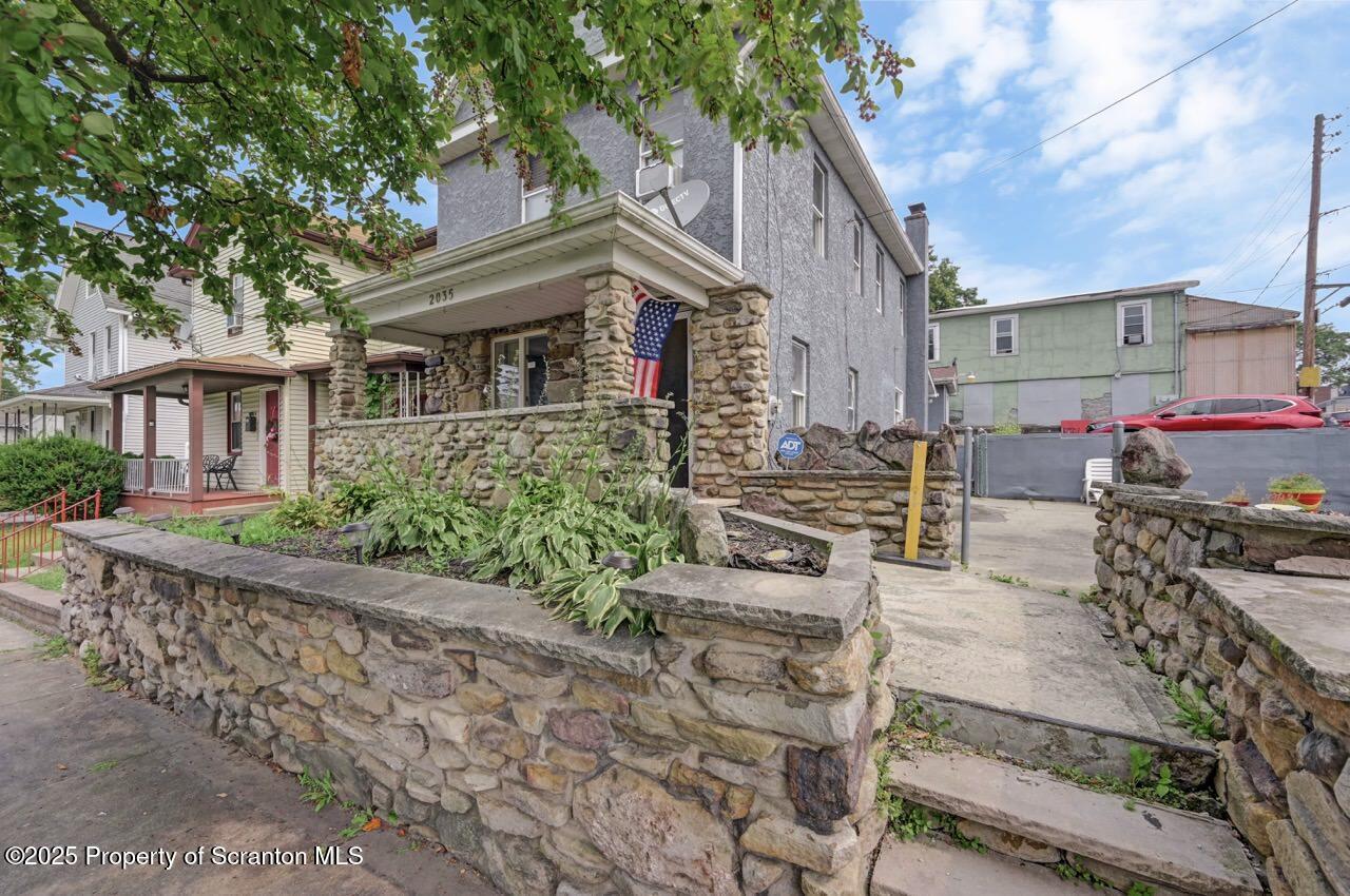 a front view of a house with garden