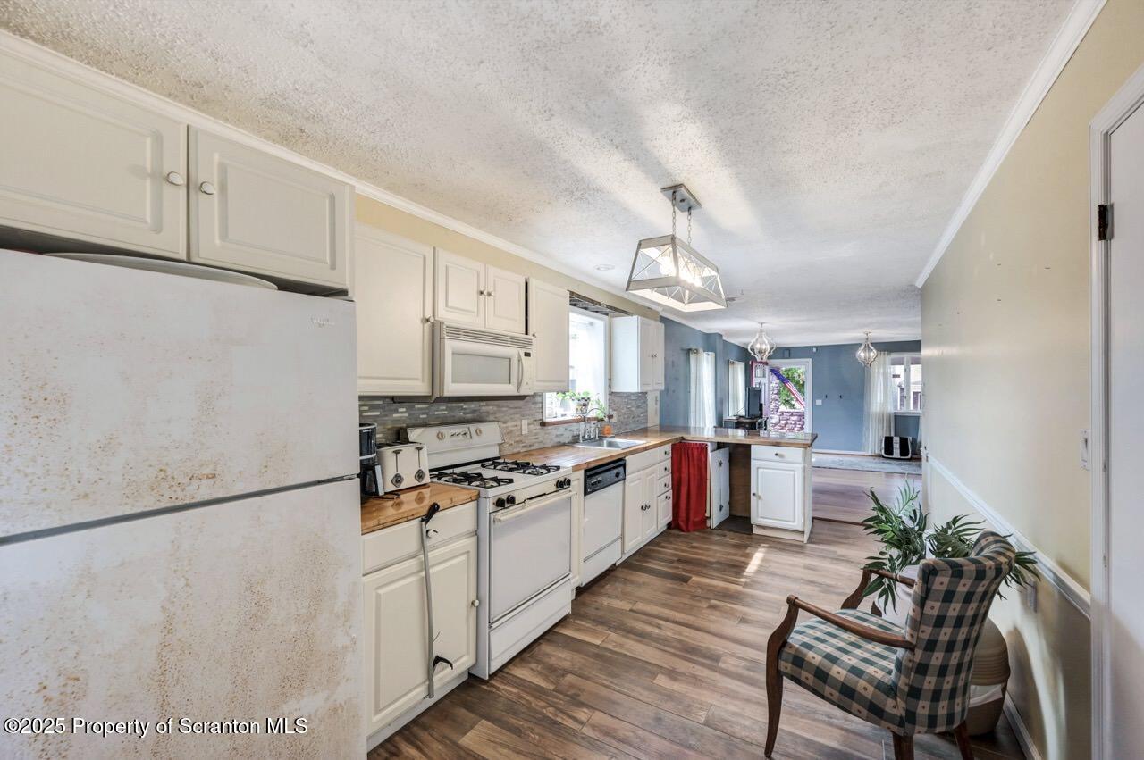 2035 Delaware Street Dunmore, PA 18512 - Photo 12 of 44 a kitchen with stainless steel appliances a refrigerator a stove a sink and white cabinets
