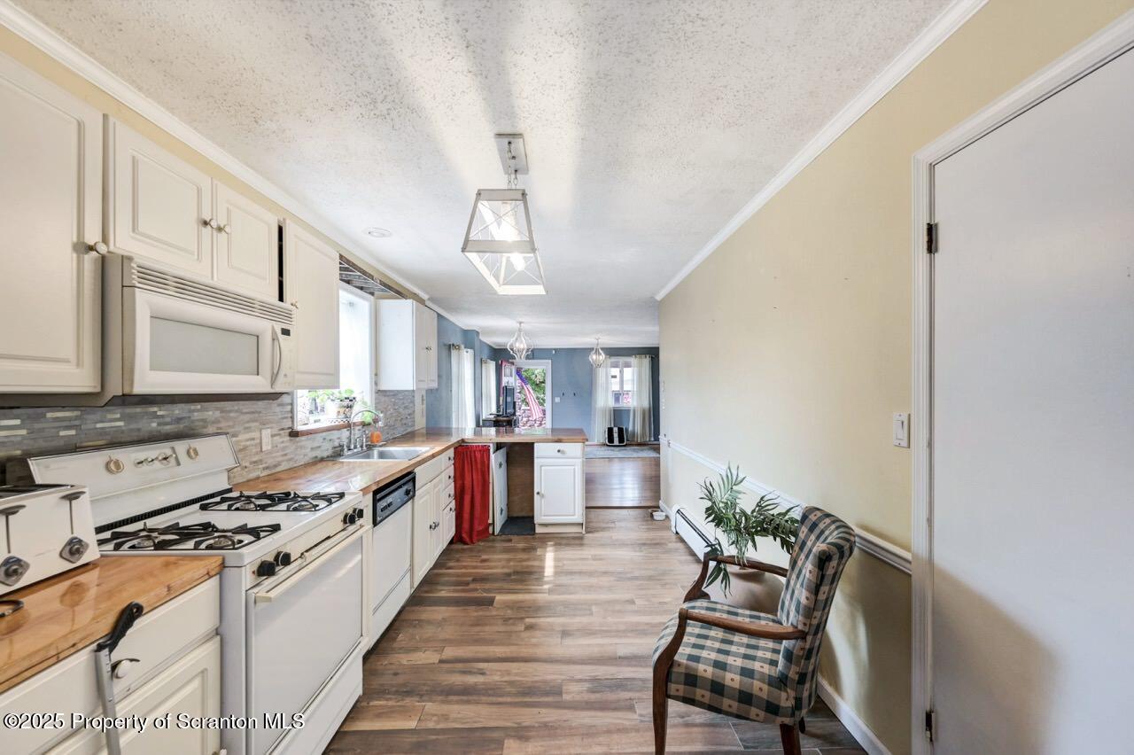 2035 Delaware Street Dunmore, PA 18512 - Photo 13 of 44 a large white kitchen with a stove and a refrigerator