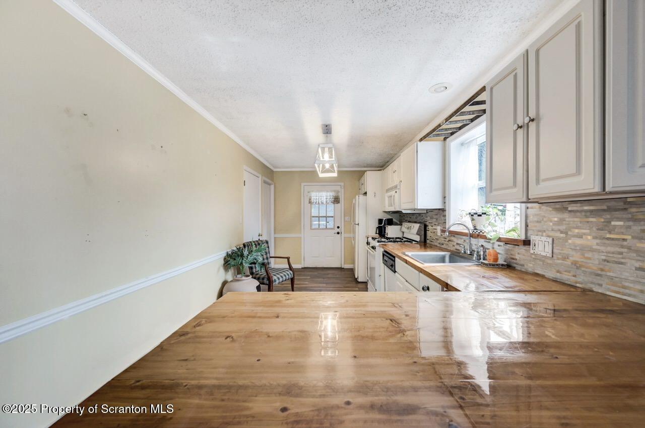 2035 Delaware Street Dunmore, PA 18512 - Photo 15 of 44 a large white kitchen with granite countertop a large window and white stainless steel appliances