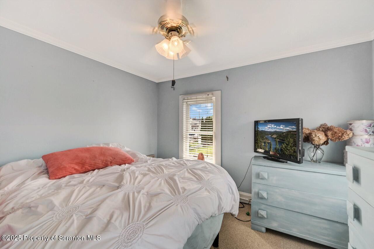 2035 Delaware Street Dunmore, PA 18512 - Photo 21 of 44 a bedroom with a bed and a chandelier