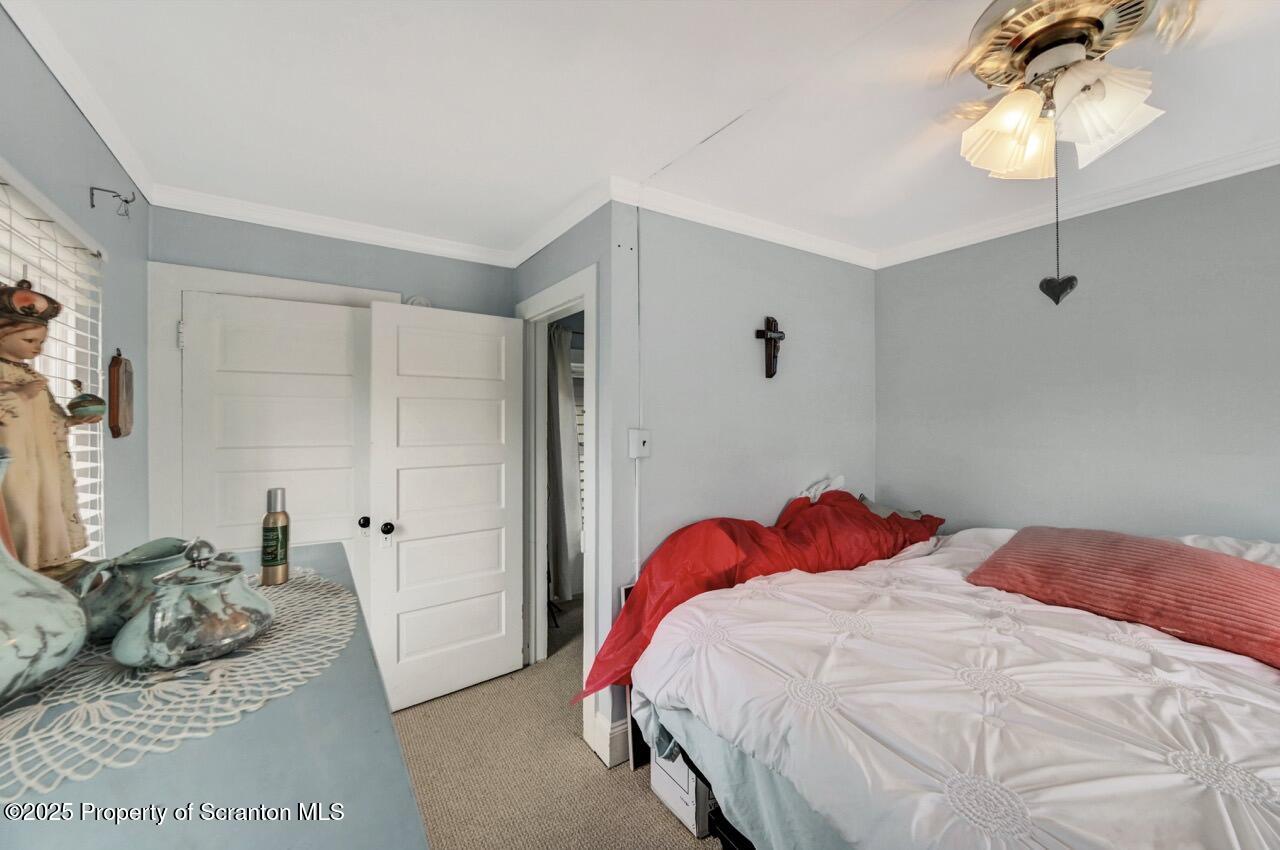 2035 Delaware Street Dunmore, PA 18512 - Photo 22 of 44 a bedroom with a bed and a chandelier