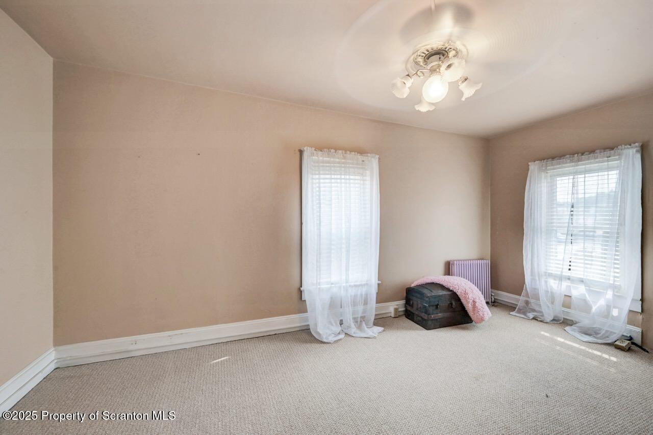 2035 Delaware Street Dunmore, PA 18512 - Photo 28 of 44 a bed room with two beds and a chandelier
