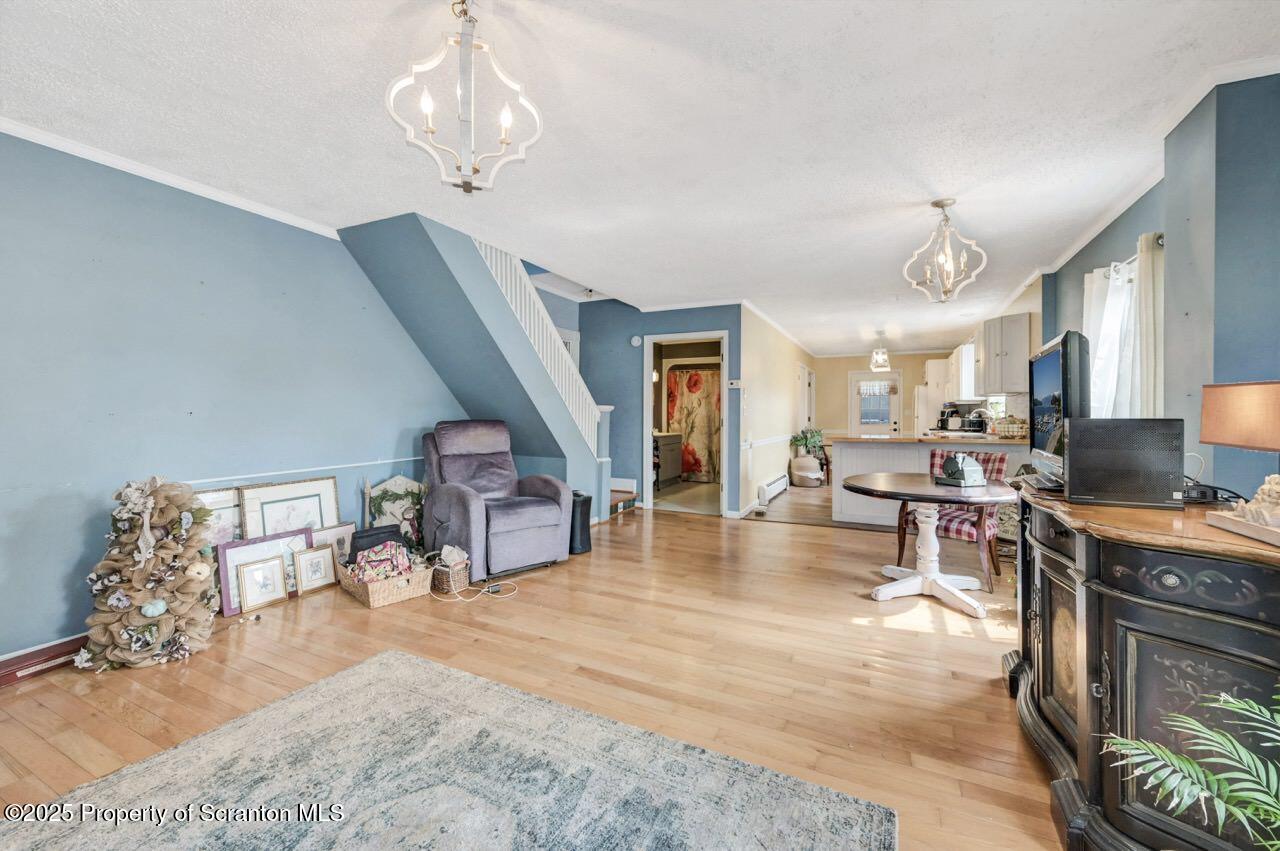 2035 Delaware Street Dunmore, PA 18512 - Photo 10 of 44 a living room with furniture and a chandelier