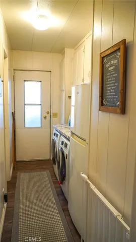 a view of a refrigerator in kitchen and utility room