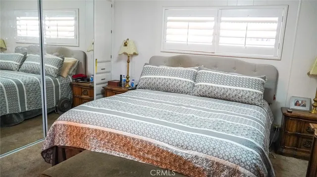 a bed sitting in a bedroom next to a window