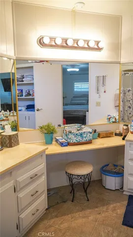a room with table chairs and a potted plant