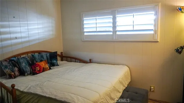 a bed sitting in a bedroom next to a window