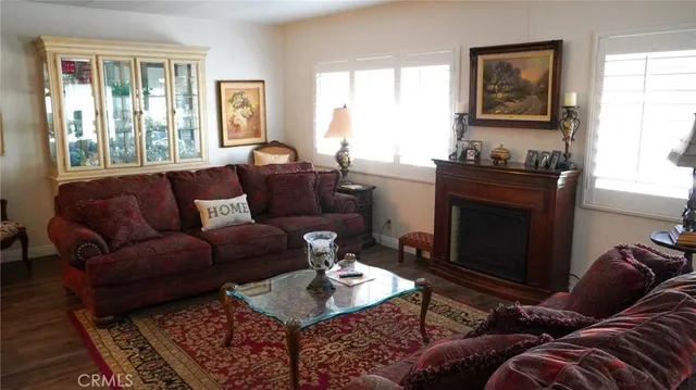 a living room with furniture a large window and a fireplace