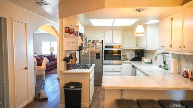 a kitchen with stainless steel appliances granite countertop a refrigerator and stove
