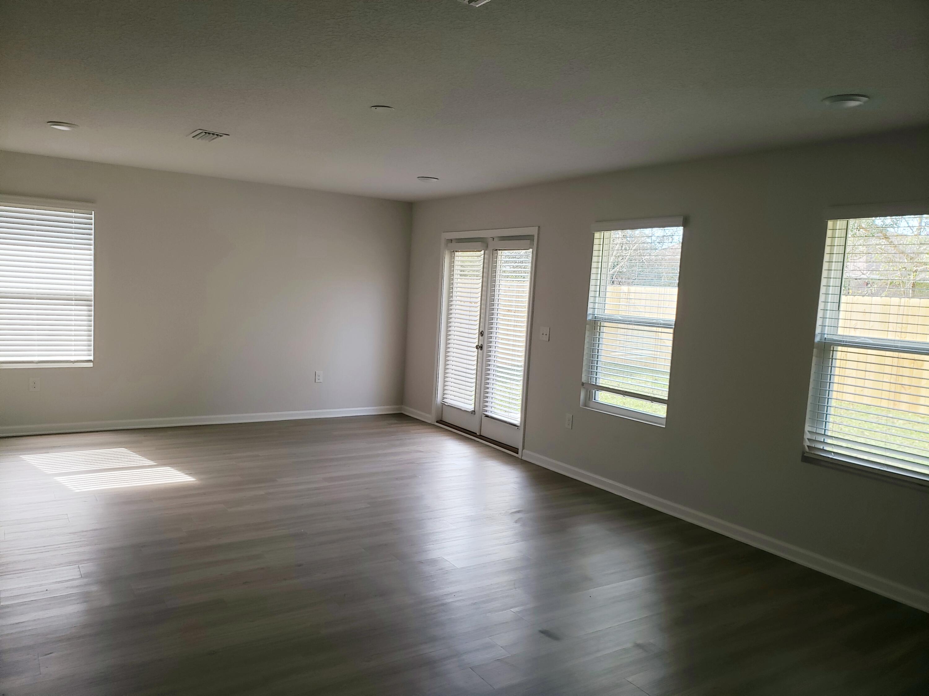 2875 Patriot Ridge Drive Crestview, FL 32539 - Photo 12 of 39 an empty room with wooden floor and windows