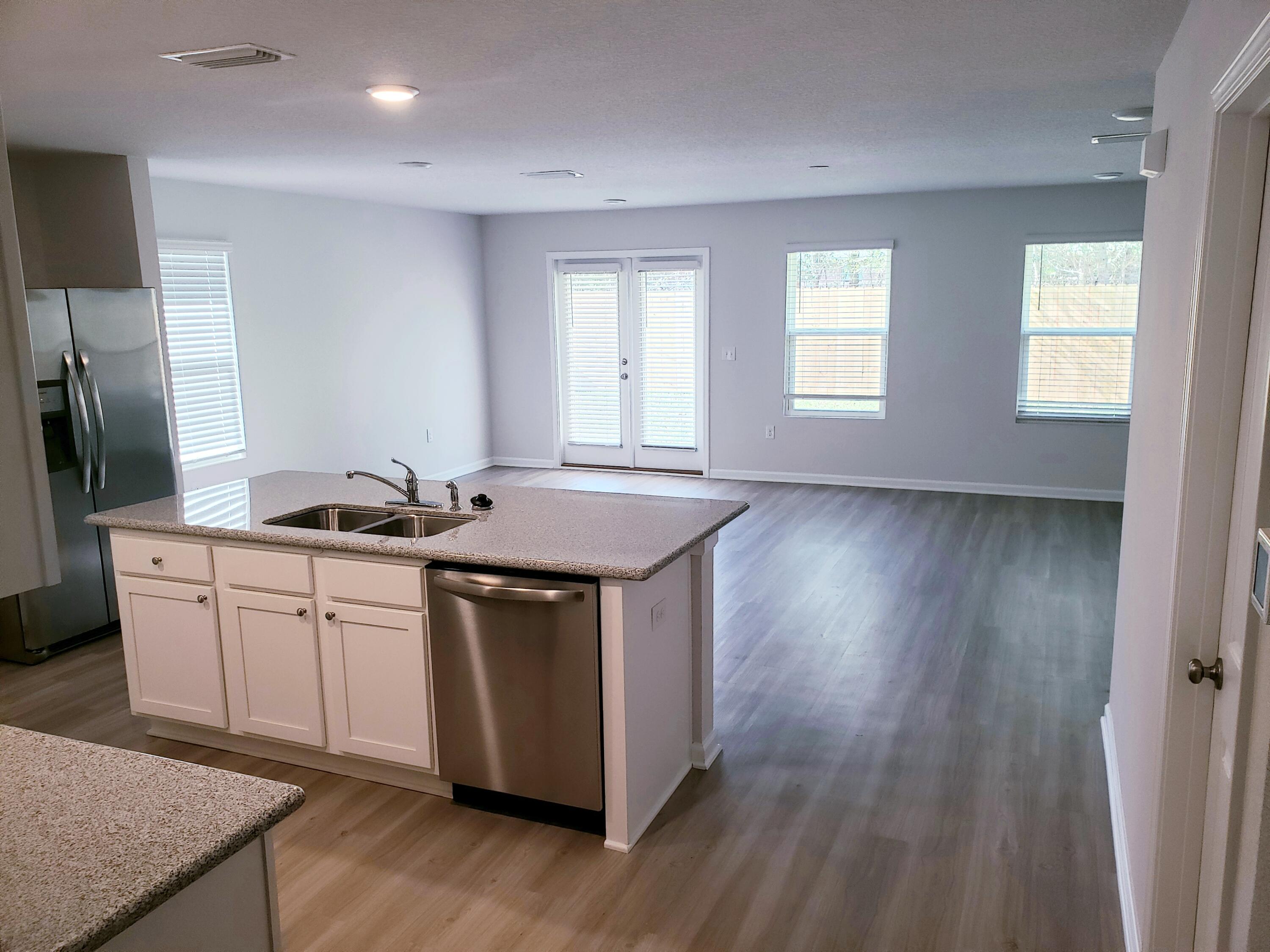 2875 Patriot Ridge Drive Crestview, FL 32539 - Photo 10 of 39 a kitchen with sink a refrigerator and wooden floor