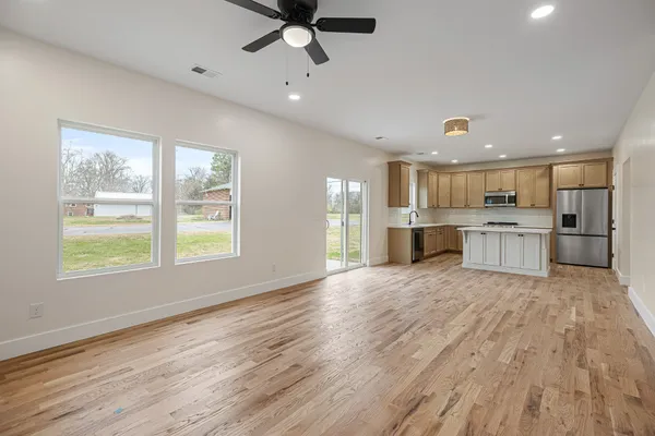a view of kitchen with wooden floor and windows