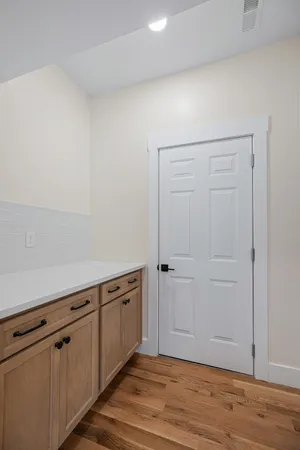 a view of a kitchen with wooden floor