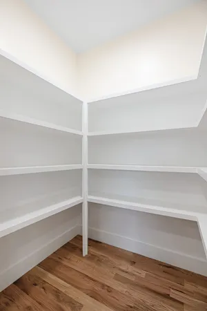 a view of a room with shelf and wooden floor