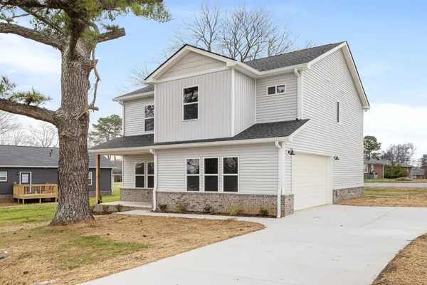 a front view of a house with a yard and garage