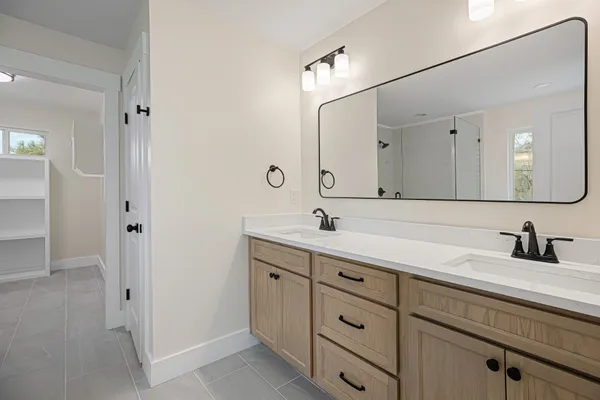a bathroom with a double vanity sink and mirror