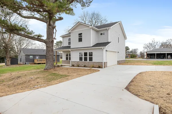 a front view of a house with a yard and garage