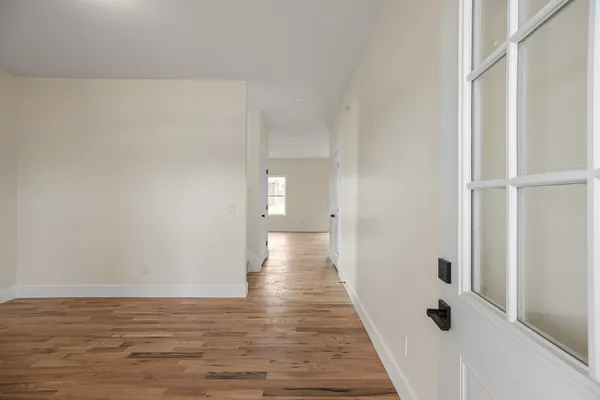 a view of a hallway with wooden floor