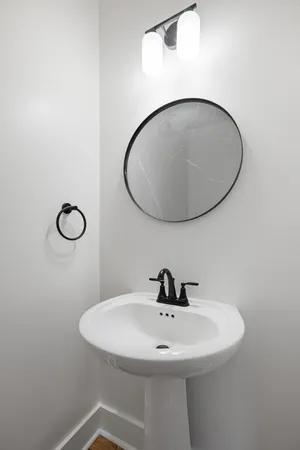a bathroom with a sink and mirror