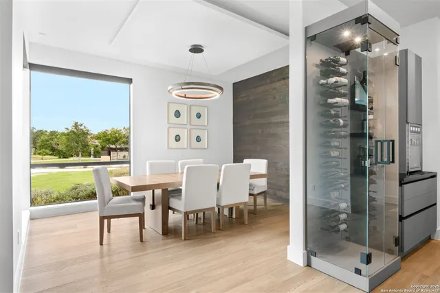 a view of a dining room with furniture and a large window