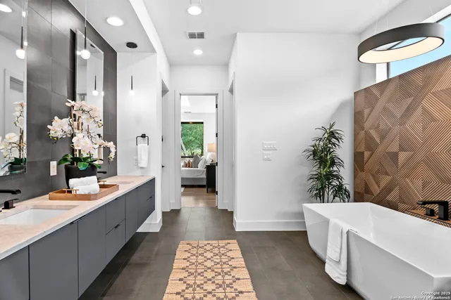 a bathroom with a double vanity sink and mirror