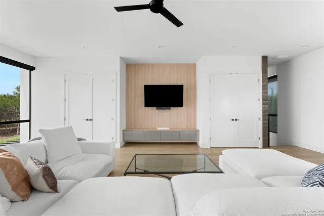a view of a living room and kitchen with furniture and floor to ceiling window