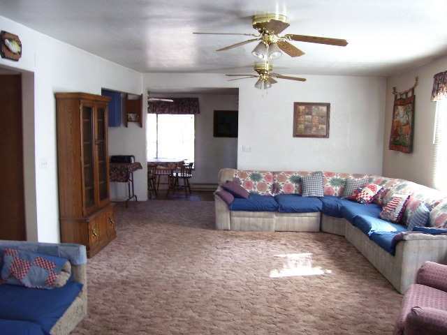 195 East Woodland Lake Road Pinetop, AZ 85935 - Photo 2 of 5 a living room with furniture and a chandelier