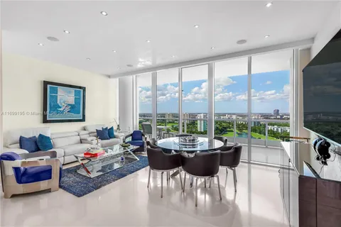 a living room with furniture and a floor to ceiling window
