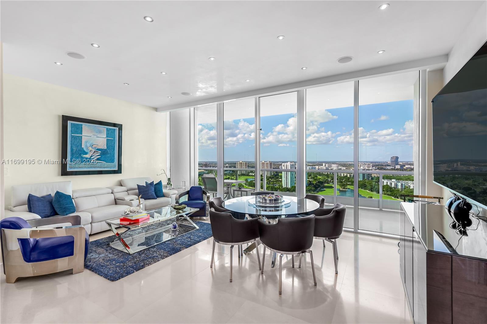 20155 Northeast 38th Court, Unit 2903 Aventura, FL 33180 - Photo 12 of 28 a living room with furniture and a floor to ceiling window