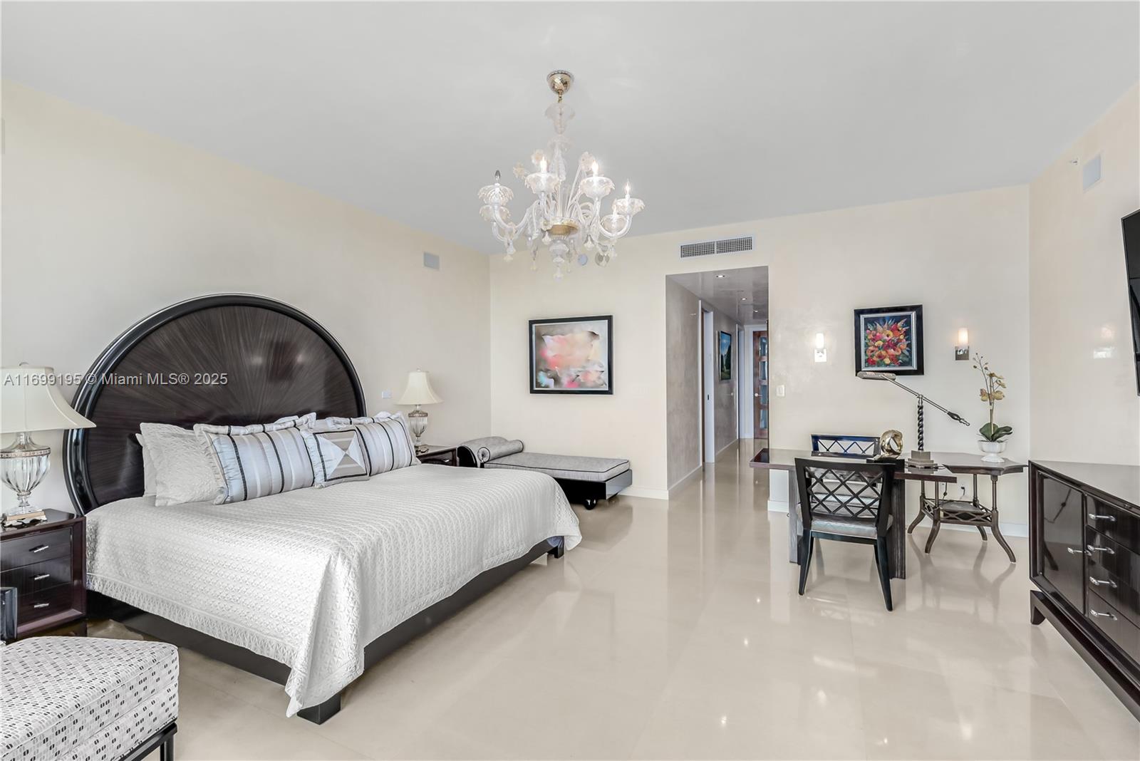 20155 Northeast 38th Court, Unit 2903 Aventura, FL 33180 - Photo 15 of 28 a bedroom with a bed and a chair