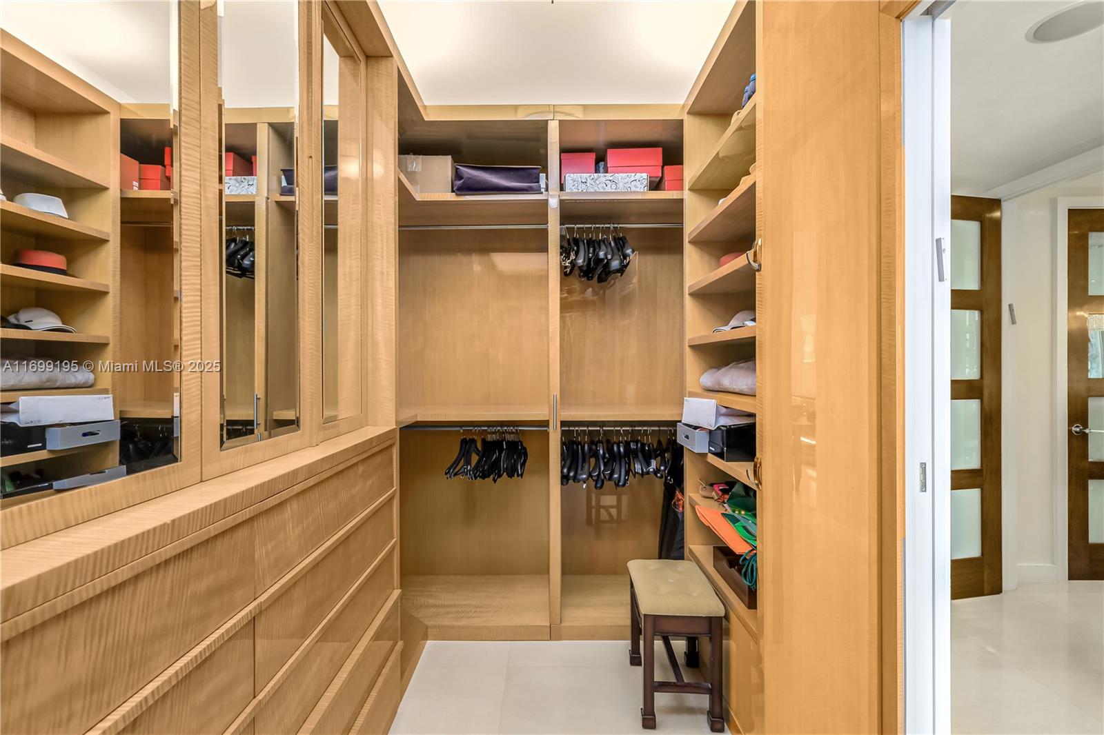 20155 Northeast 38th Court, Unit 2903 Aventura, FL 33180 - Photo 16 of 28 a view of walk in closet with clothes and shoes