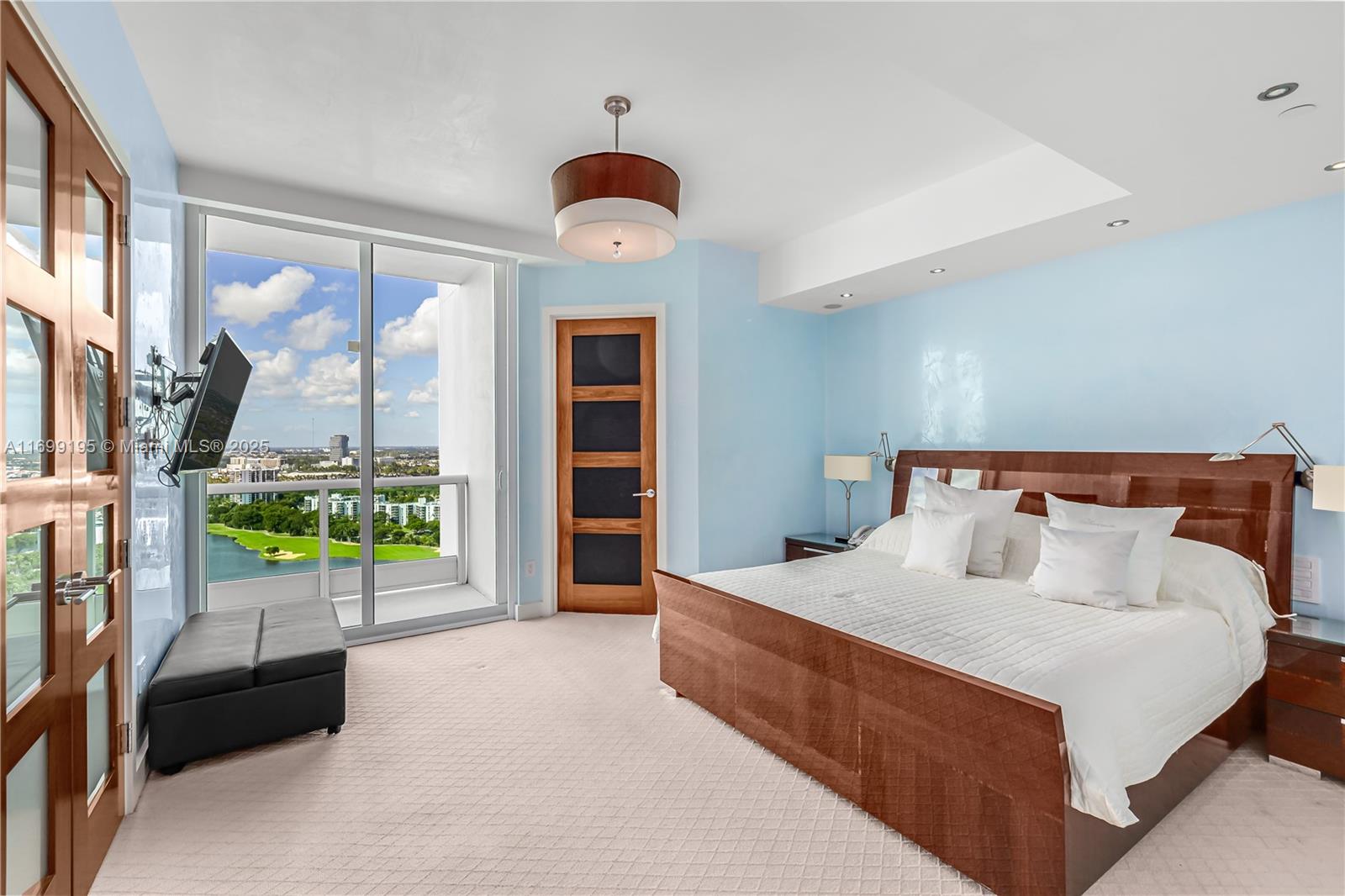 20155 Northeast 38th Court, Unit 2903 Aventura, FL 33180 - Photo 22 of 28 a bedroom with a bed and a large window