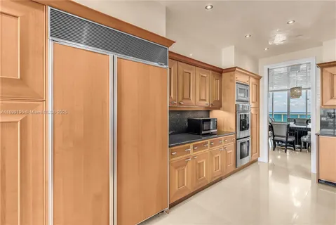 a kitchen with stainless steel appliances a refrigerator sink and cabinets