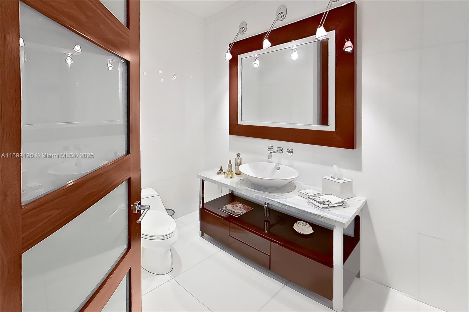20155 Northeast 38th Court, Unit 2903 Aventura, FL 33180 - Photo 6 of 28 a bathroom with a sink mirror vanity and toilet