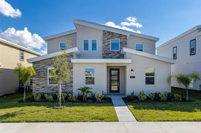 a front view of a house with a yard and garage