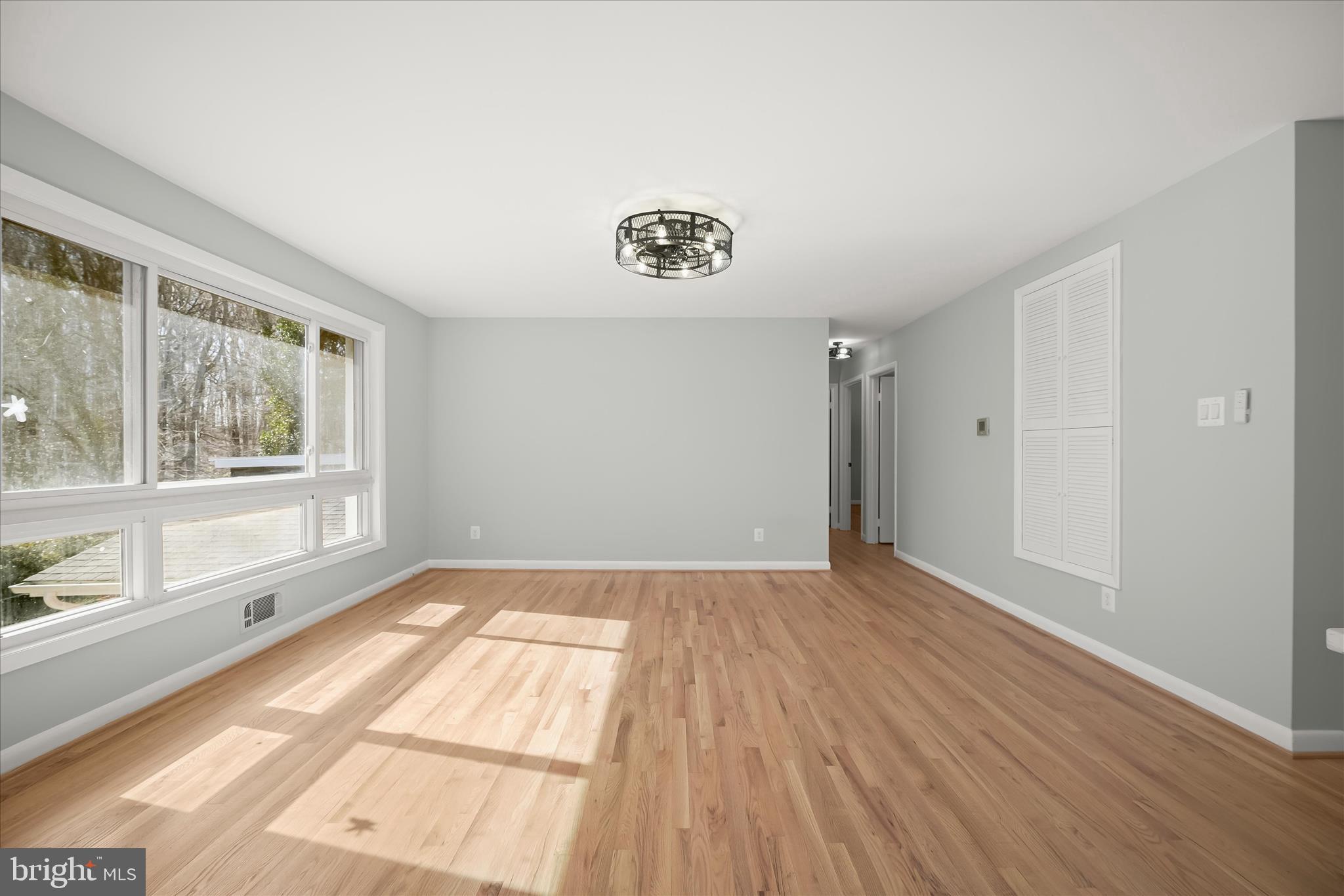 9720 Hedin Drive Silver Spring, MD 20903 - Photo 31 of 79 a view of an empty room with a window and wooden floor