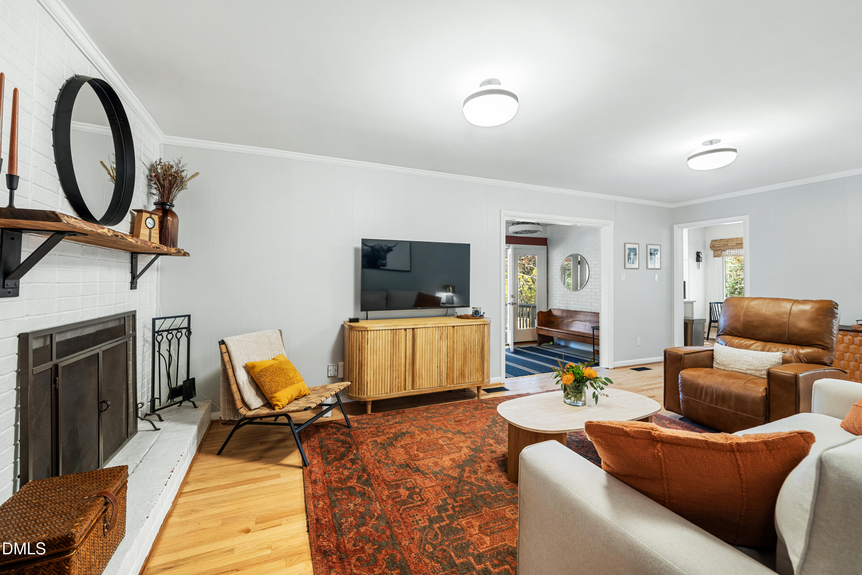 1801 Fountain Ridge Road Chapel Hill, NC 27517 - Photo 10 of 50 a living room with furniture a flat screen tv and a fireplace