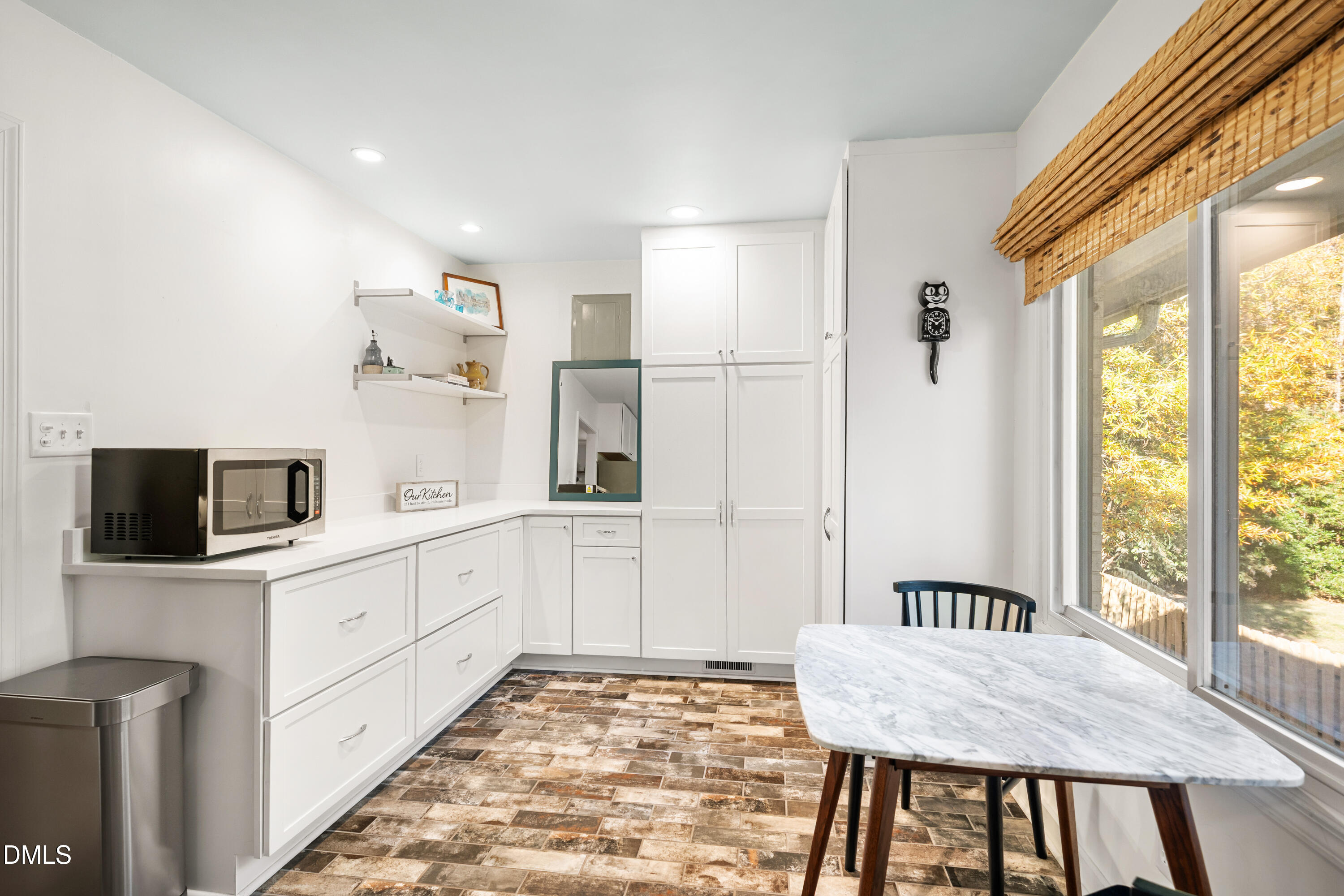 1801 Fountain Ridge Road Chapel Hill, NC 27517 - Photo 16 of 50 a kitchen with stainless steel appliances granite countertop a stove a sink a microwave a refrigerator with white cabinets and wooden floor