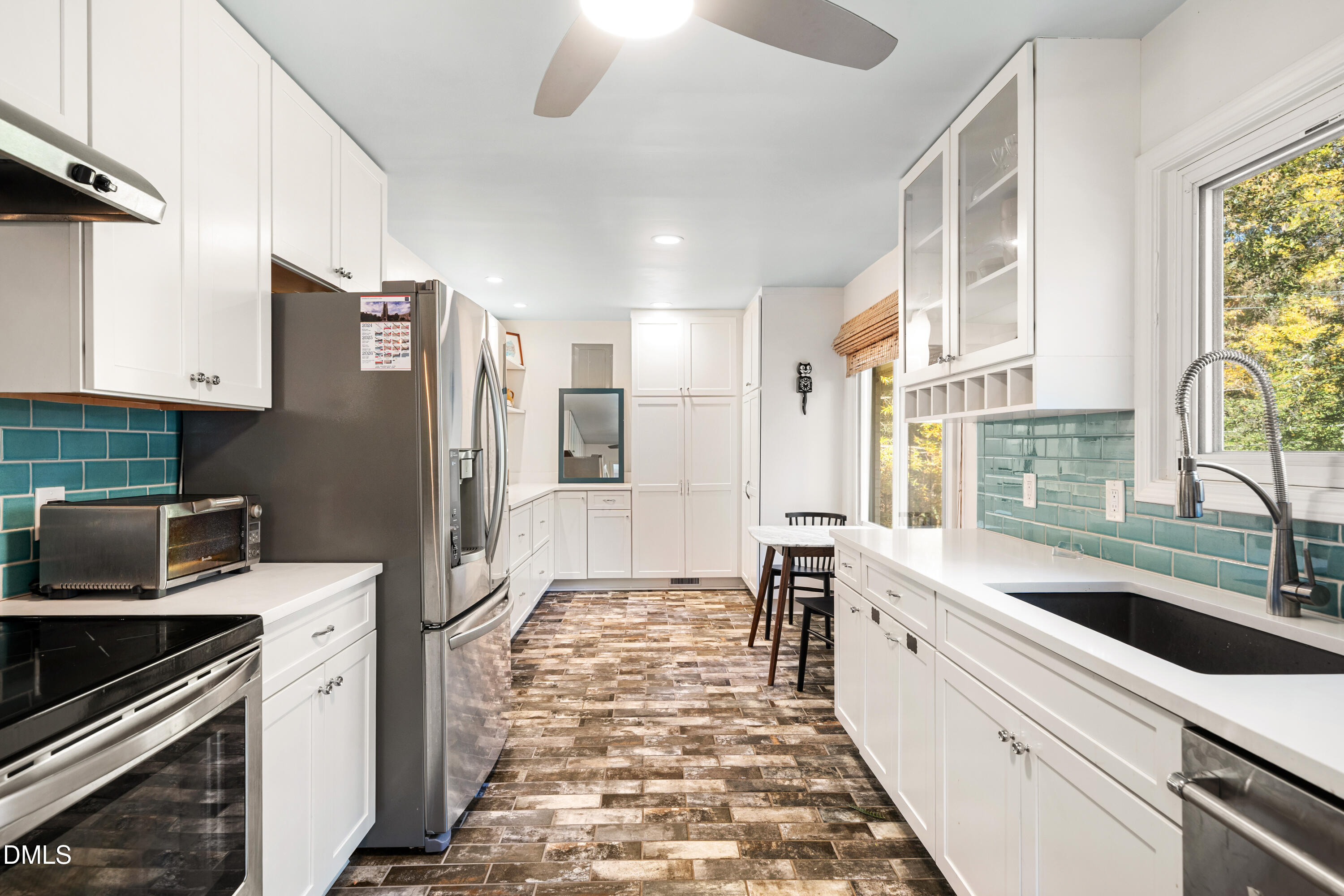1801 Fountain Ridge Road Chapel Hill, NC 27517 - Photo 18 of 50 a kitchen with stainless steel appliances a refrigerator sink and cabinets