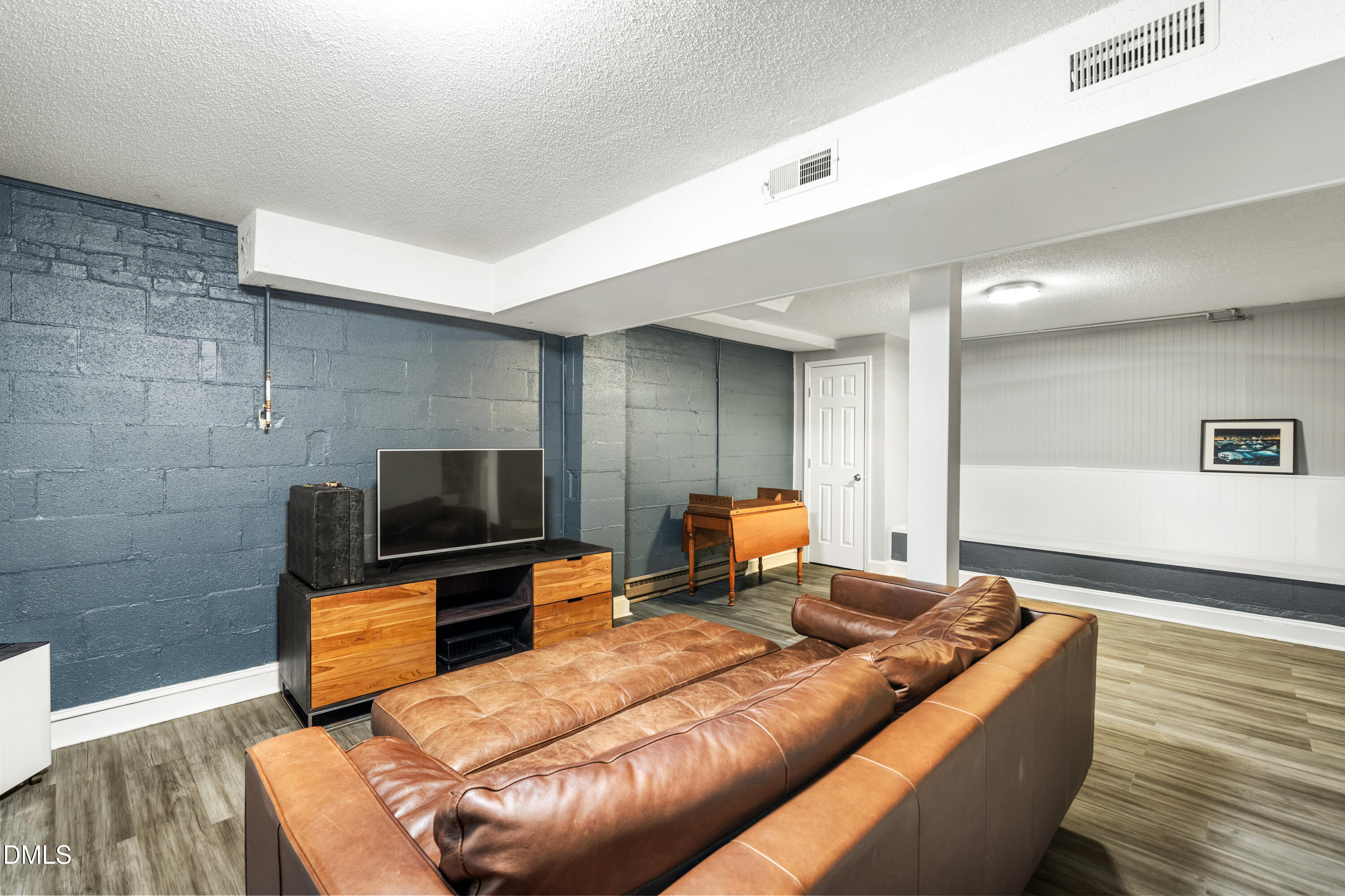 1801 Fountain Ridge Road Chapel Hill, NC 27517 - Photo 32 of 50 a living room with a flat screen tv and a couch