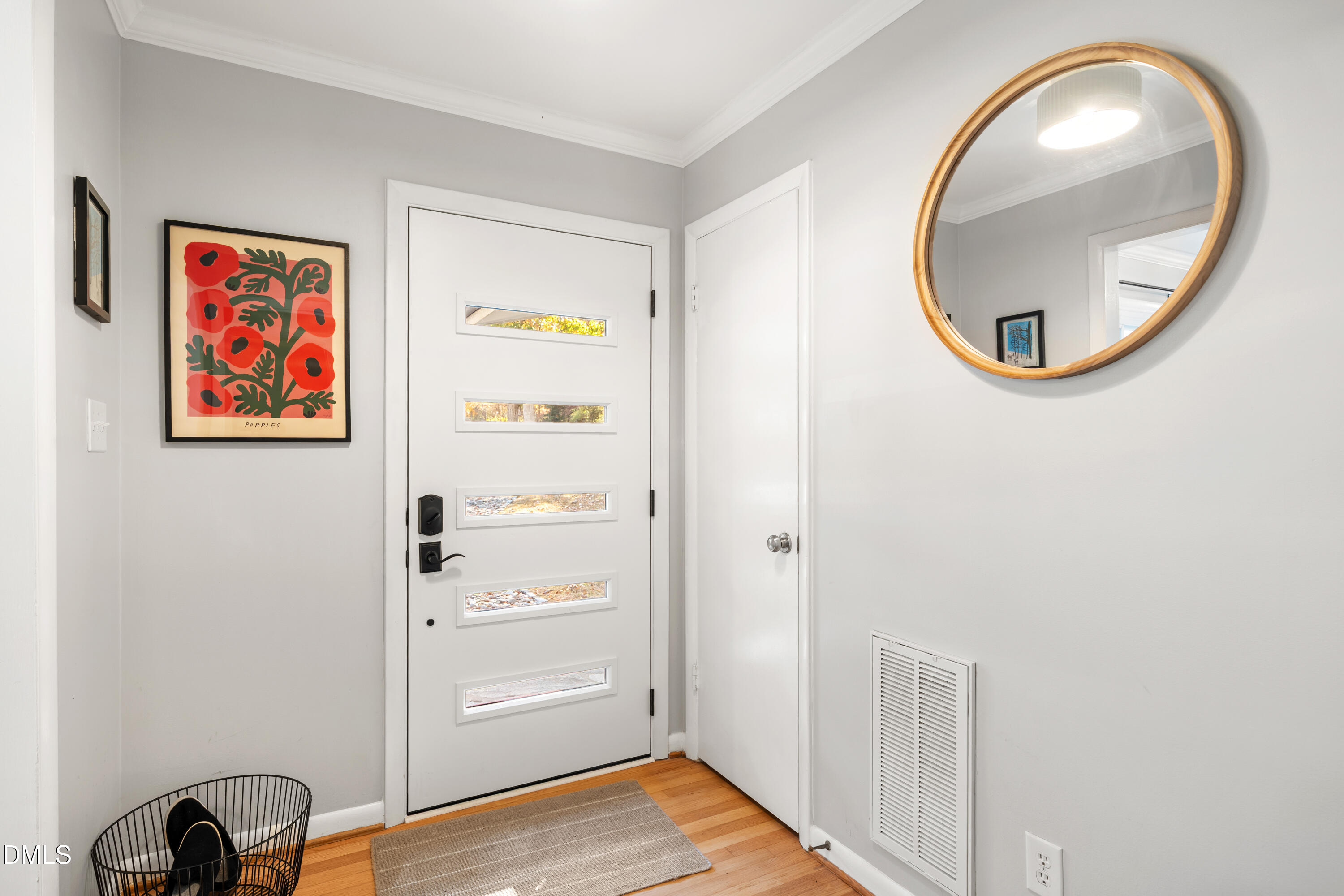 1801 Fountain Ridge Road Chapel Hill, NC 27517 - Photo 4 of 50 a view of a hallway with front door wooden floor and cabinet