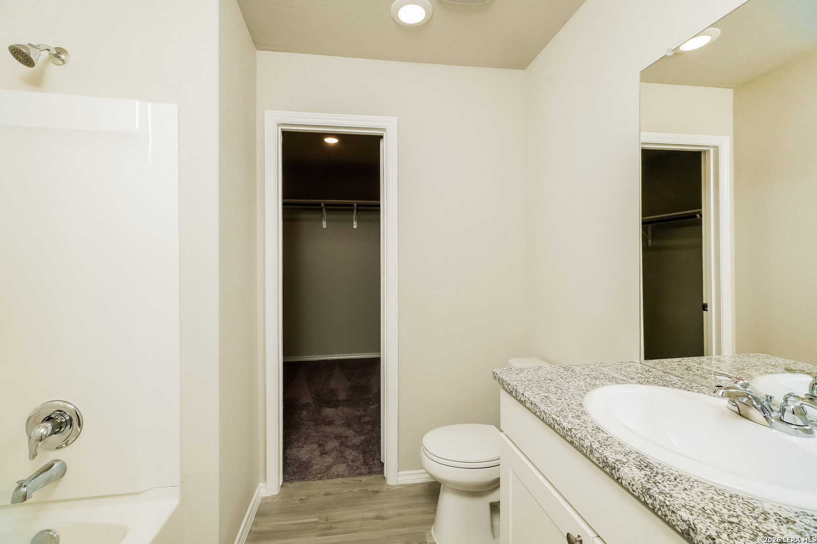 9115 Griffith Converse, TX 78109 - Photo 12 of 15 a bathroom with a granite countertop sink toilet and shower