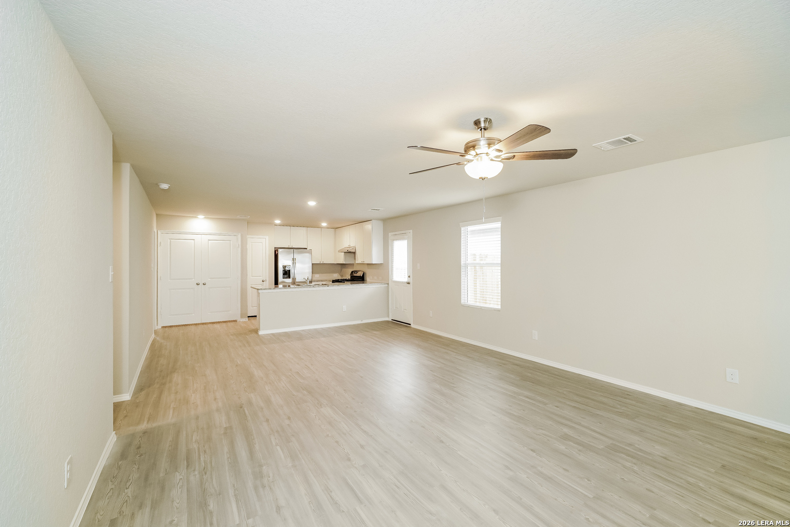 9115 Griffith Converse, TX 78109 - Photo 4 of 15 wooden floor in an empty room with a window