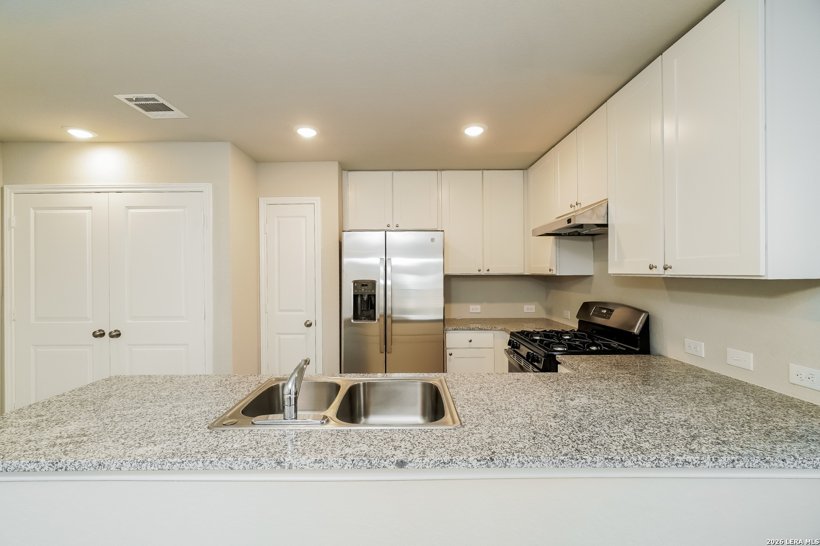 9115 Griffith Converse, TX 78109 - Photo 6 of 15 a kitchen with stainless steel appliances granite countertop a sink refrigerator and cabinets