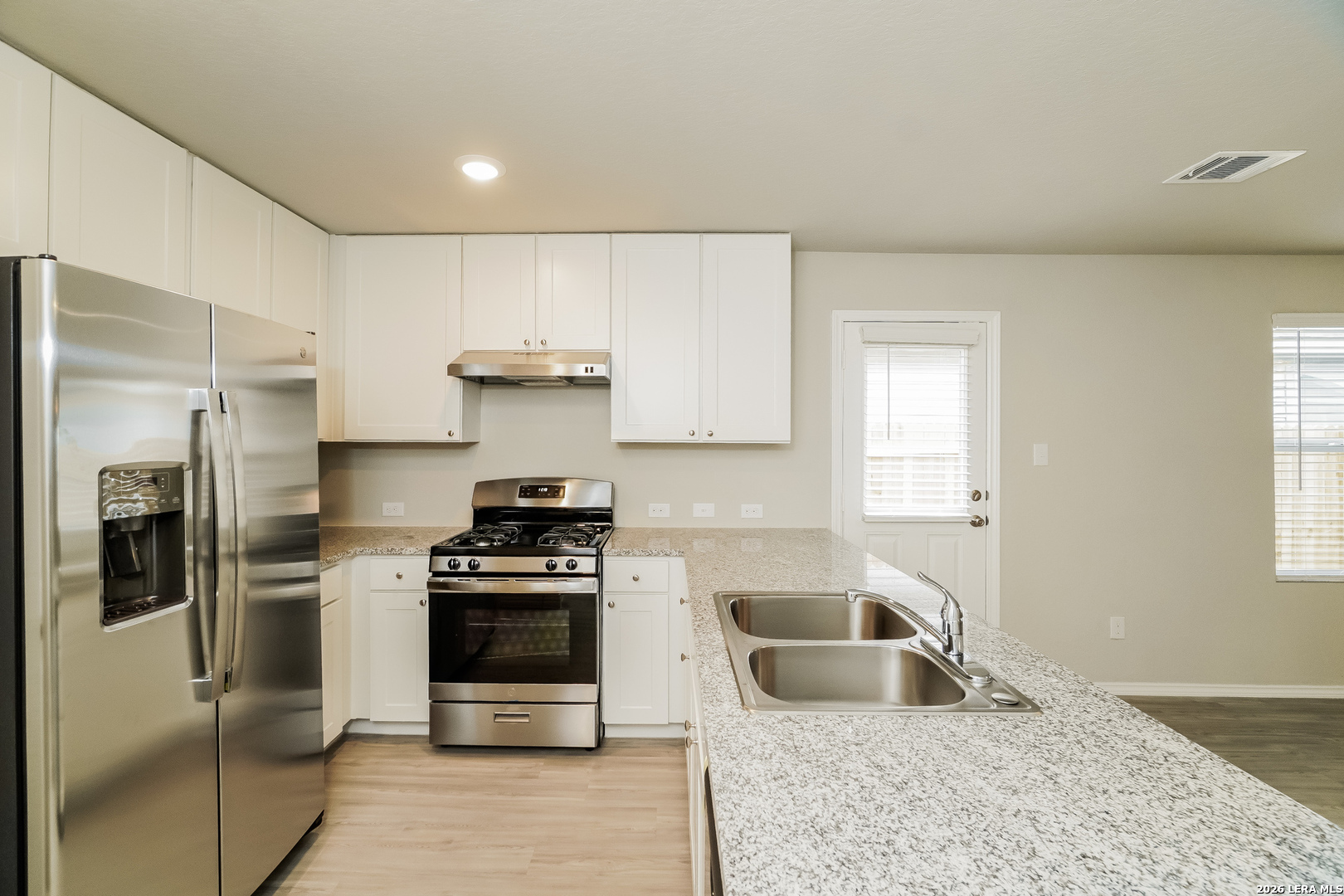 9115 Griffith Converse, TX 78109 - Photo 7 of 15 a kitchen with a refrigerator a stove a microwave and cabinets