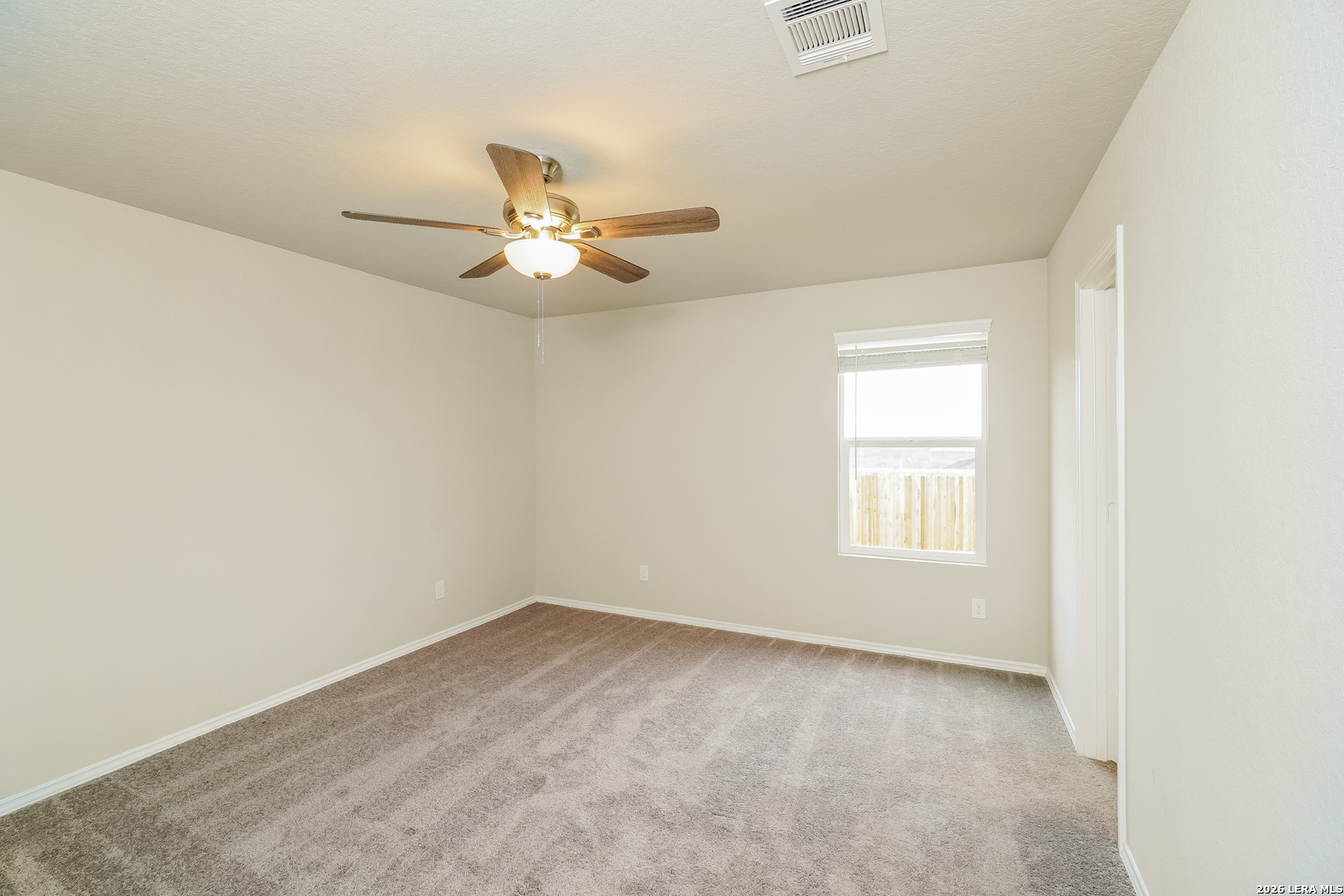 9115 Griffith Converse, TX 78109 - Photo 8 of 15 an empty room with a window and a fan