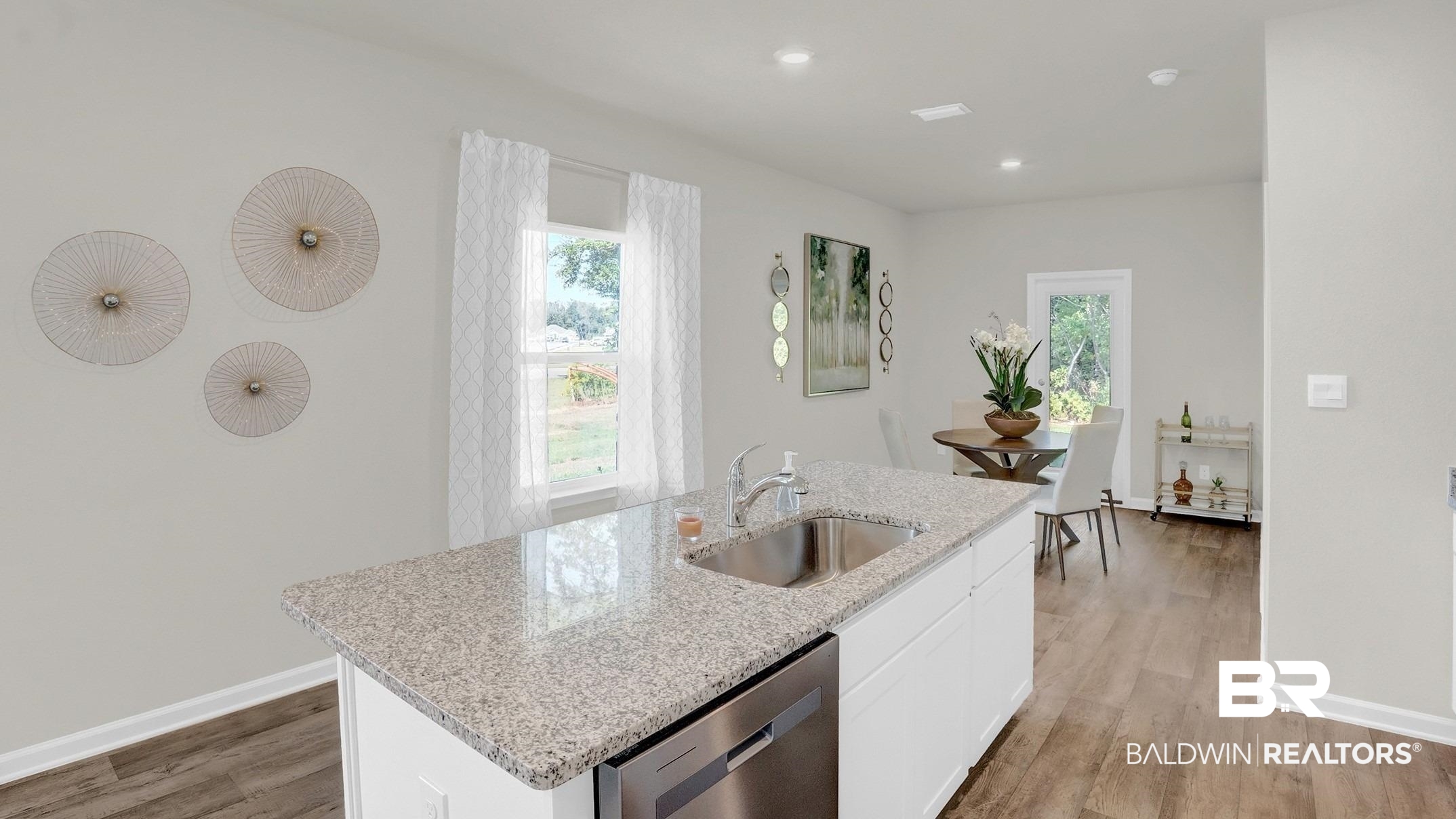 13330 Shea Circle Foley, AL 36535 - Photo 10 of 15 Kitchen island with granite countertop and undermount sink, stainless steel dishwasher, wood-finish flooring, and recessed lighting