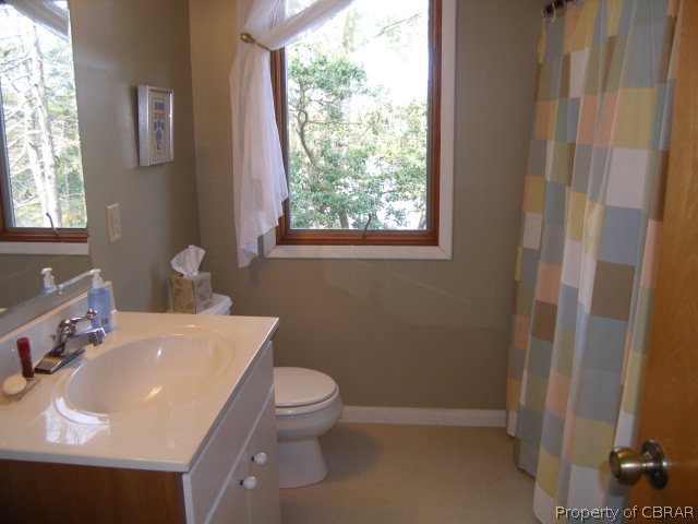 879 West Point Road Lancaster, VA 22503 - Photo 19 of 38 a bathroom with a sink toilet and vanity